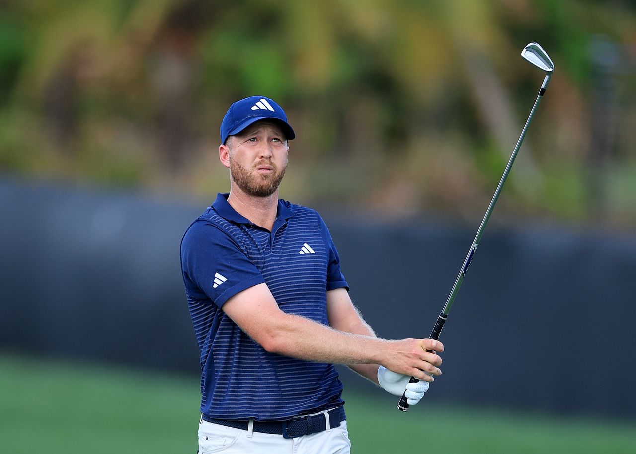 Daniel Berger hits an iron from the fairway