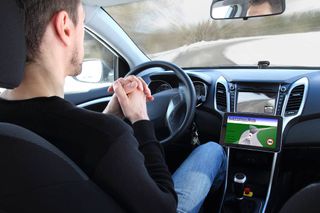 Man behind the wheel of a self-driving car