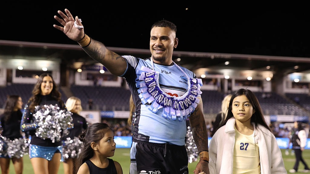 Sione Katoa of the Sharks waves at the crowd on a farewell lap of honor.