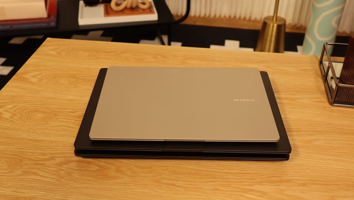 Three Samsung Galaxy Book3 piled up on a wooden table