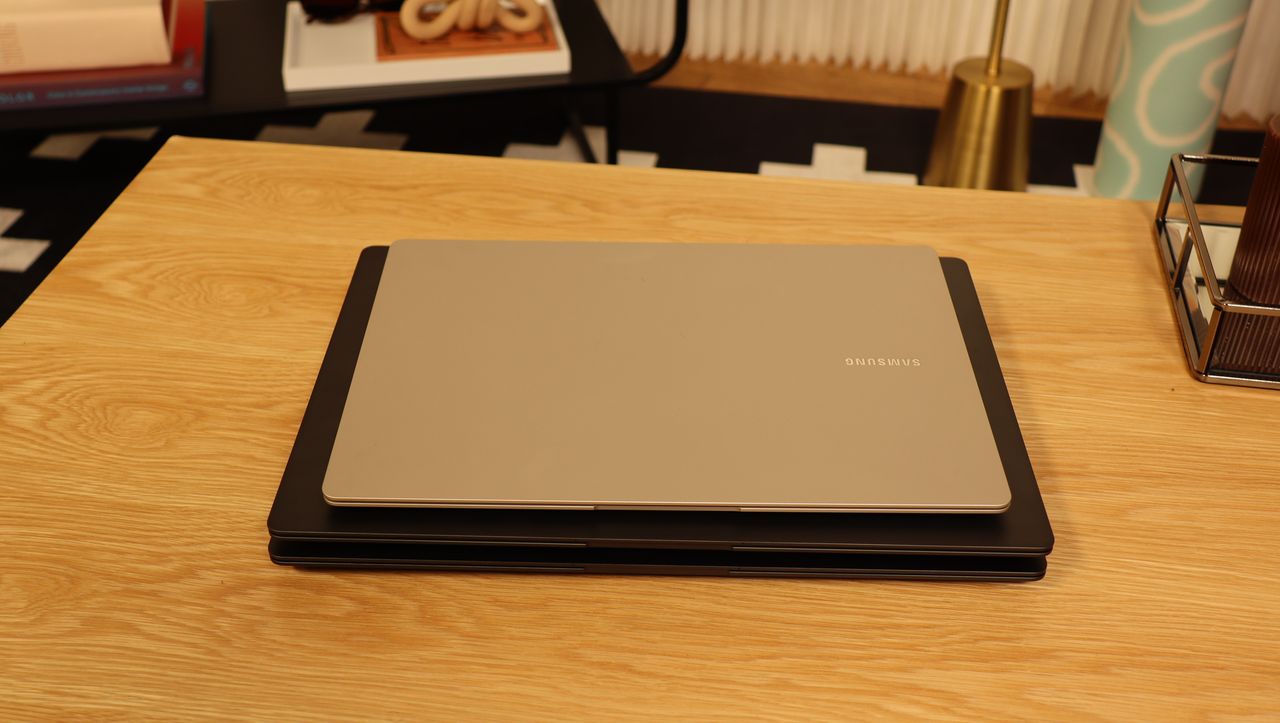 Three Samsung Galaxy Book3 piled up on a wooden table