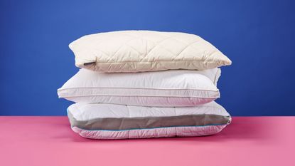 Best pillows stacked on pink and purple background 