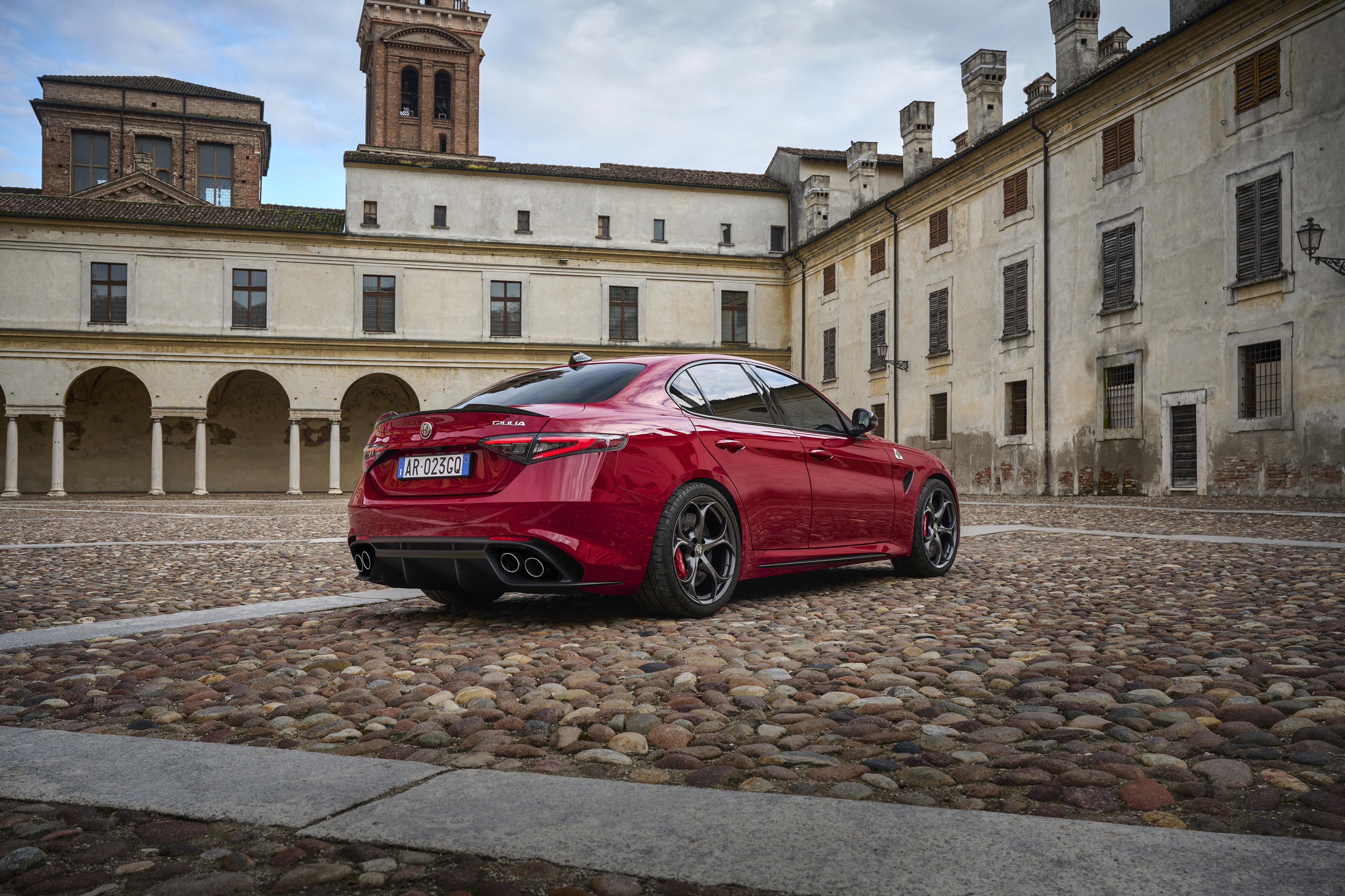 A red Alfa Romeo Giulia zooming about on an airfield