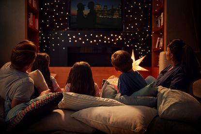 Family enjoying a cosy night in with a movie
