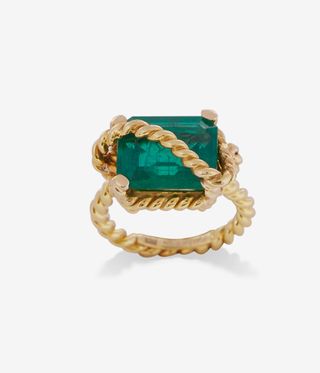 Emerald ring with gold rope crossing over it