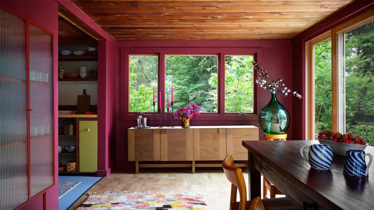 dining room with burgundy walls and timber ceiling