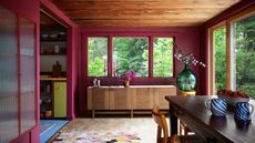 dining room with burgundy walls and timber ceiling