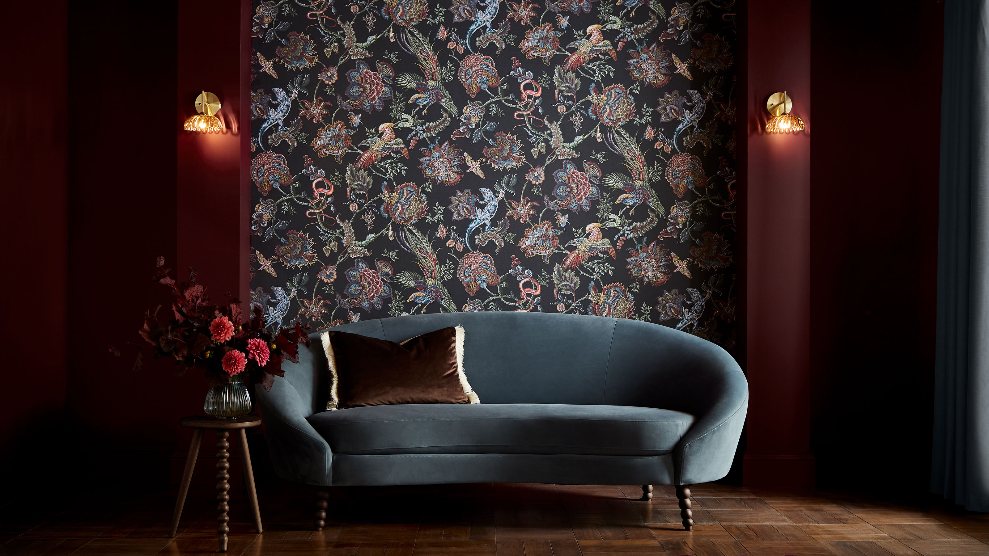 Graham and Brown divine damson paint on walls with eternal weave wallpaper and a blue velvet curving sofa