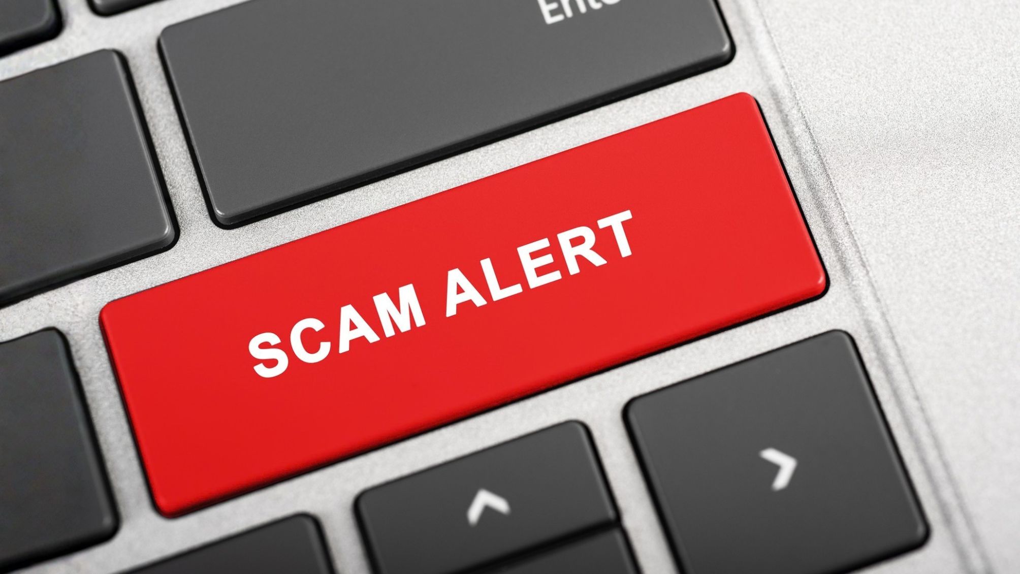 A keyboard with a large red SCAM ALERT key