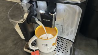 Philips 5400 Series Bean to Cup Coffee Machine dispensing foamed milk