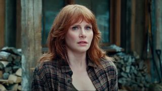 Bryce Dallas Howard stands in shock in front of her cabin in Jurassic World Dominion.