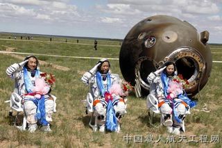 The crew of Shenzhou 10, China's fifth human spaceflight mission, salutes after a safe landing in inner Mongolia on the morning of June 26 local time in 2013. The crew is, from left: Zhang Xiaoguang, Shenzhou 10 commander Nie Haisheng and Wang Yaping, China's second female astronaut.