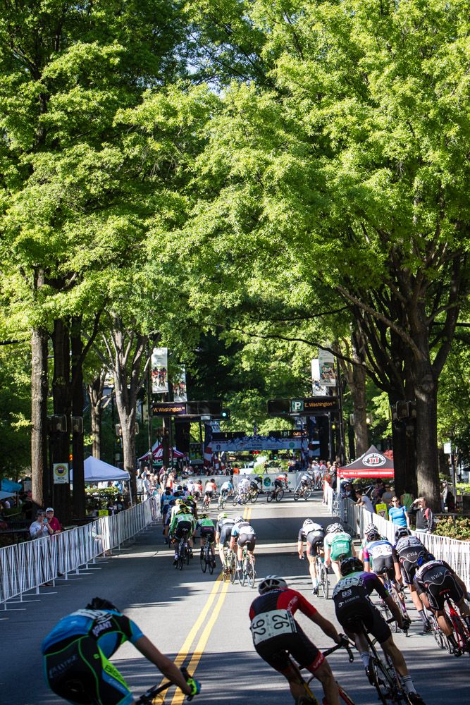 Riders go single file along todays tree lined course