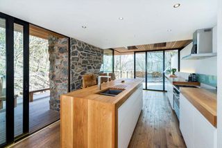 Kitchen-diner in contemporary glass, timber and stone extension