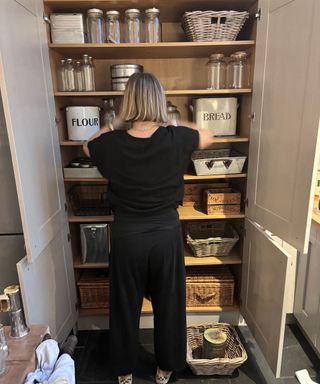 kitchen organizer sorting out a larder cupboard