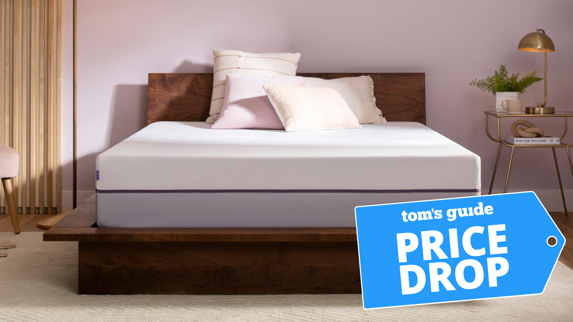 A Purple Plus Mattress on a bed frame in a bedroom, a Tom's Guide Price Drop deals graphic in the bottom right corner