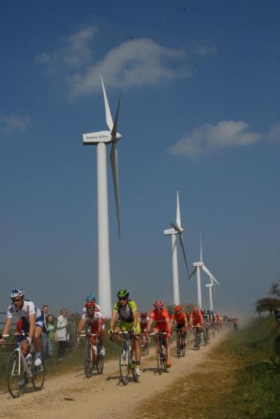 The peloton passes some modern windmills that help to power Brittany.