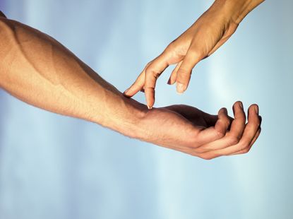 two hands touching, a couple.