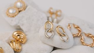 selection of earrings displayed on a rock background