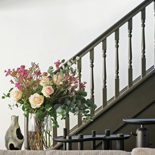 Black staircase and banister against grey walls