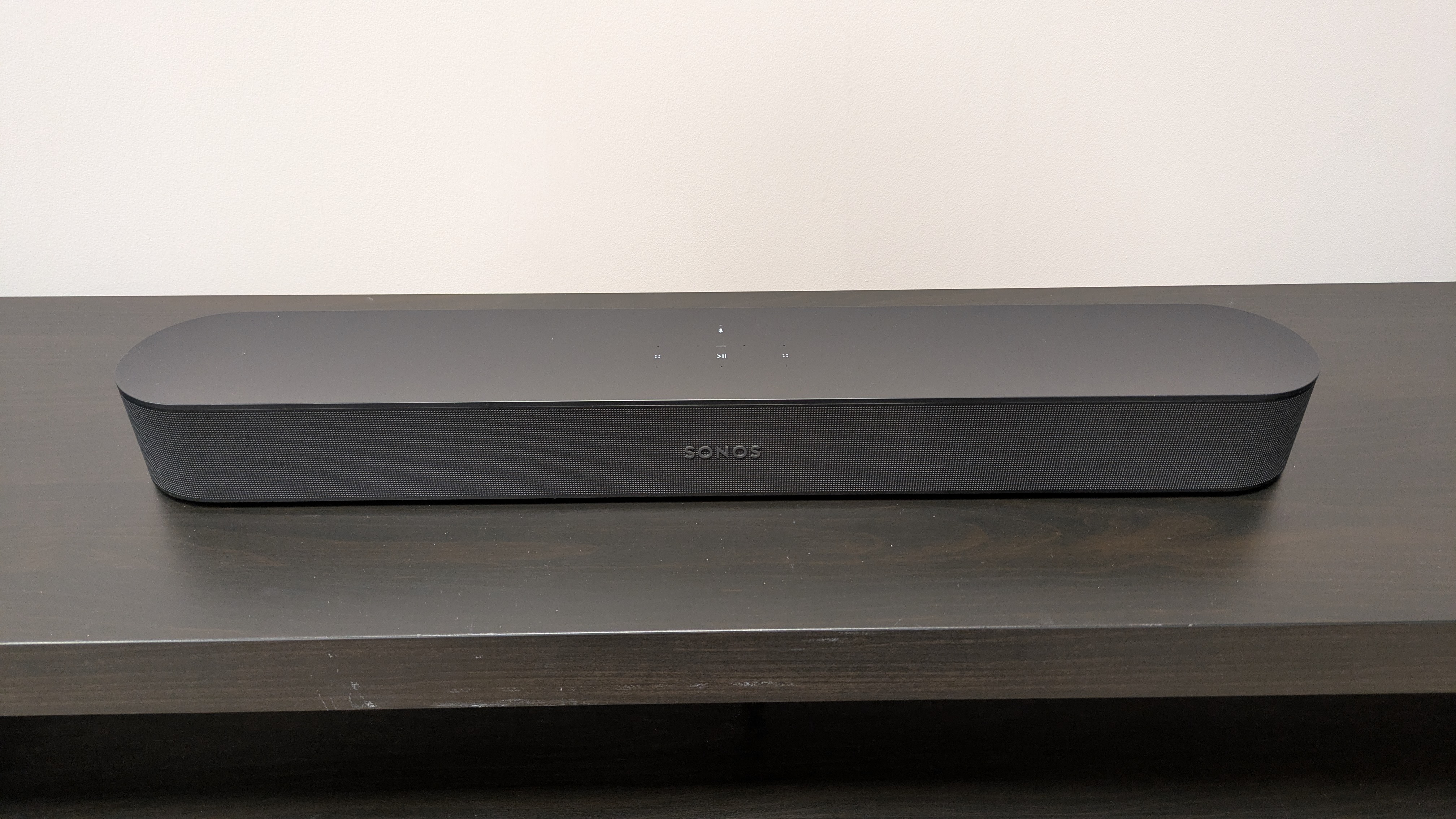 Sonos Beam on dark wood stand