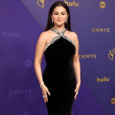 Selena Gomez wears a black maxi dress with a crystal embellished top design.