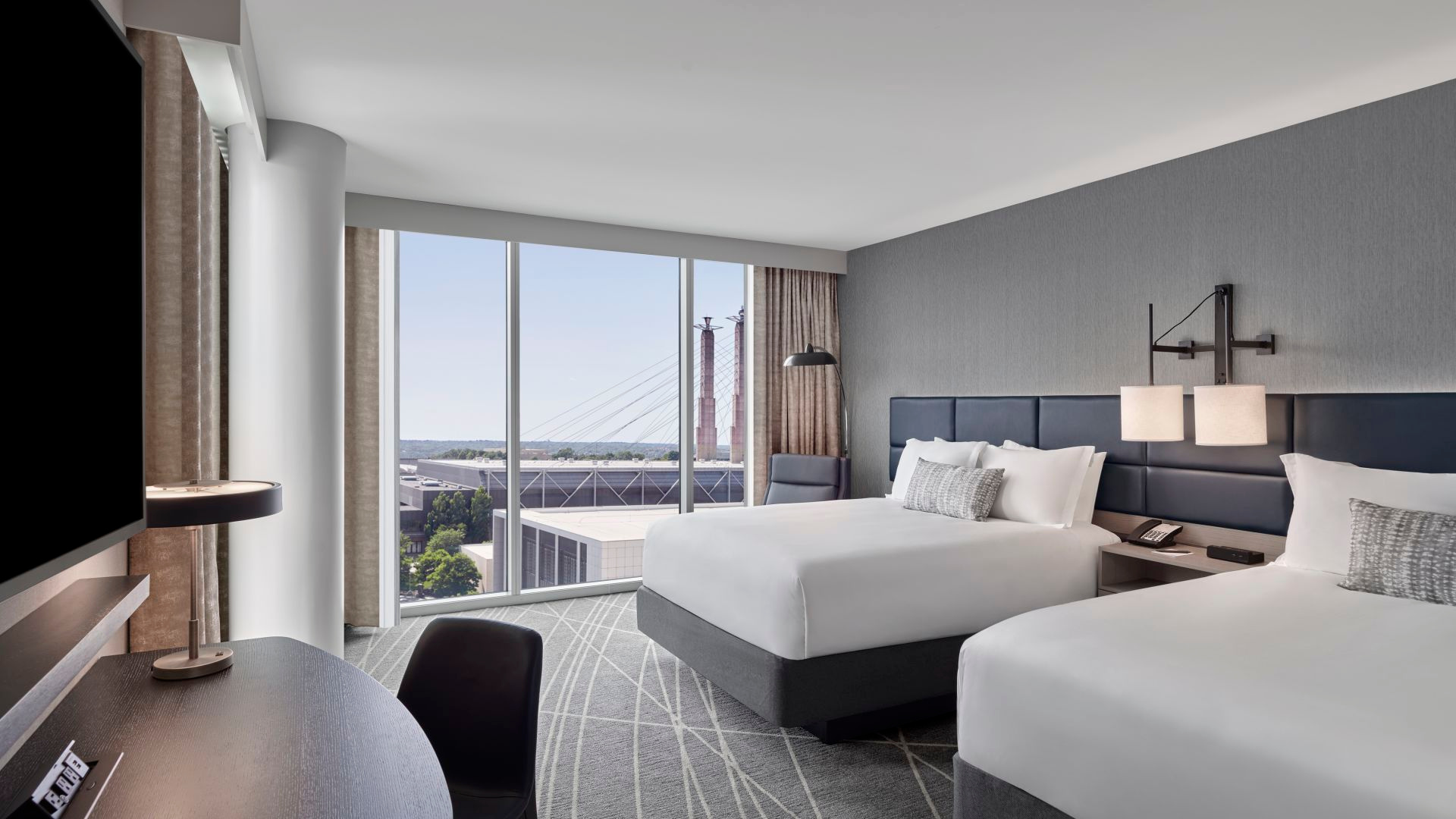 A luxurious hotel bedroom with white bedding 