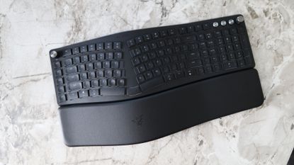 Razer Pro Type Ergo ergonomic keyboard on marble surface