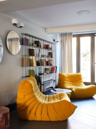 Light grey living room with yellow chairs