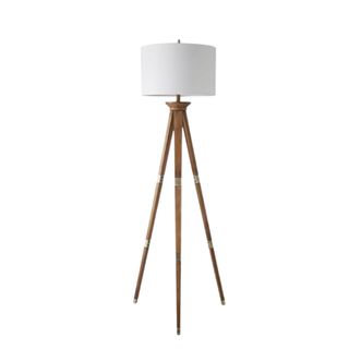 A wooden tripod floor lamp with round white light shade