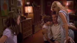 Michael C. Hall as Dexter hugging Julie Benz as Rita and her son with her daughter nearby on Dexter