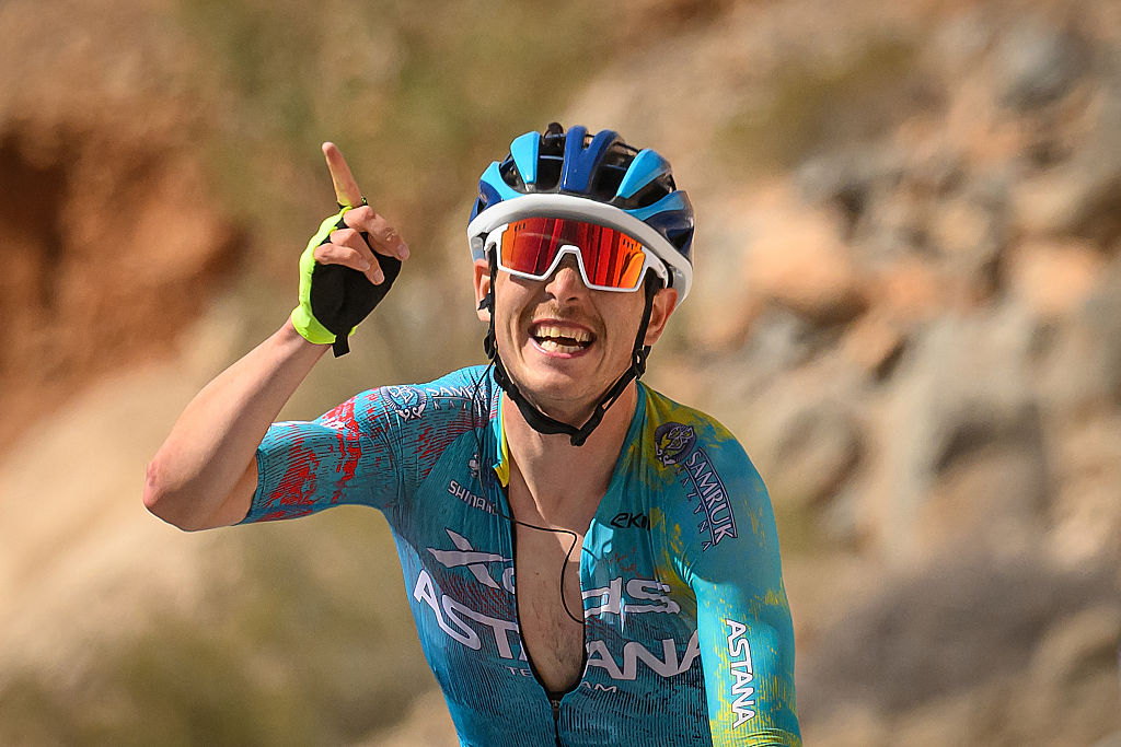 XDS Astana Team's Italian rider Christian Scaroni celebrates while crossing the finish line to win the 5th and last stage, and be winner overall of the Tour of Oman cycling race from Nizwa to Green Mountain, on February 11, 2026. (Photo by Loic VENANCE / AFP)
