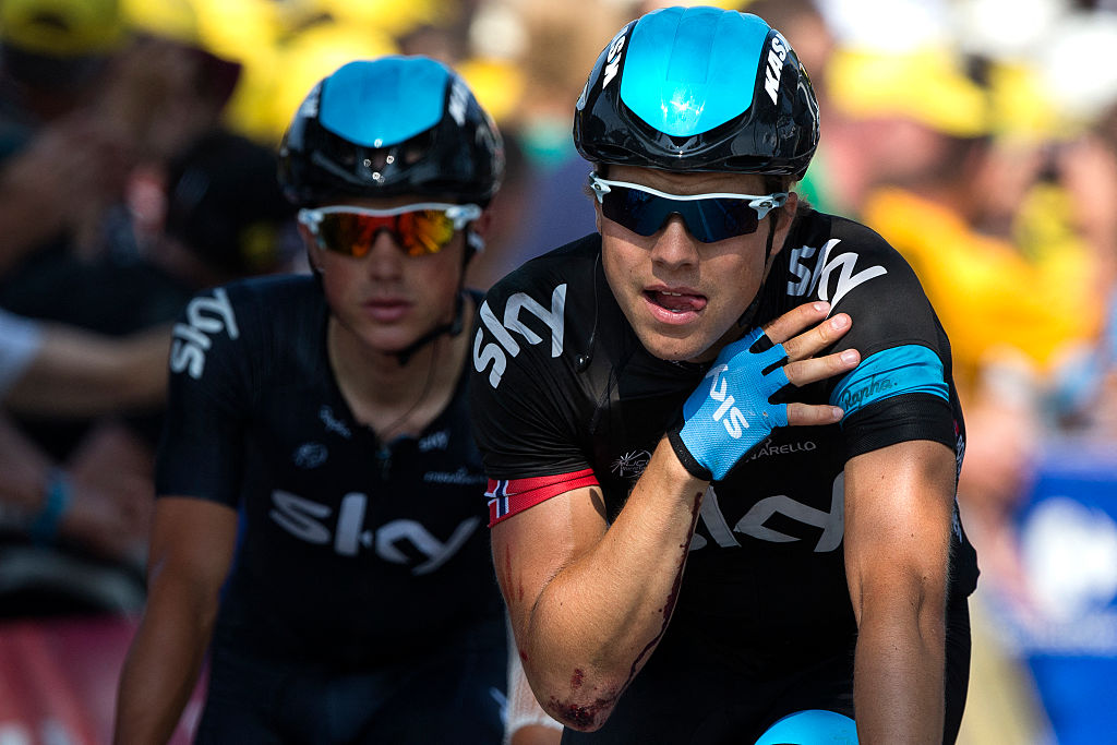 Norway's Edvald Boasson Hagen (R) is seen injured at the shoulder after falling ahead of Britain's Peter Kennaugh (L) as they cross the finish line during the 218 km twelfth stage of the 100th edition of the Tour de France cycling race on July 11, 2013 between Foug&amp;egrave;res and Tours, northwestern France. AFP PHOTO / JEFF PACHOUD (Photo by JEFF PACHOUD / POOL / AFP)
