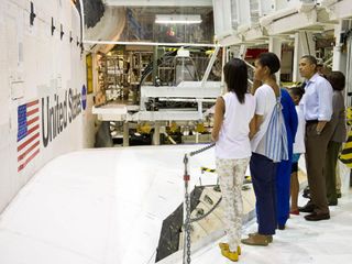 President Barack Obama, First Lady Michelle Obama, daughters Malia, left, Sasha, Marian Robinson, Astronaut Janet Kavandi and United Space Alliance project lead for thermal protection systems Terry White study the exterior of space shuttle Atlantis during
