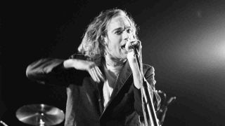 REM’s Michael Stipe performing onstage in 1987