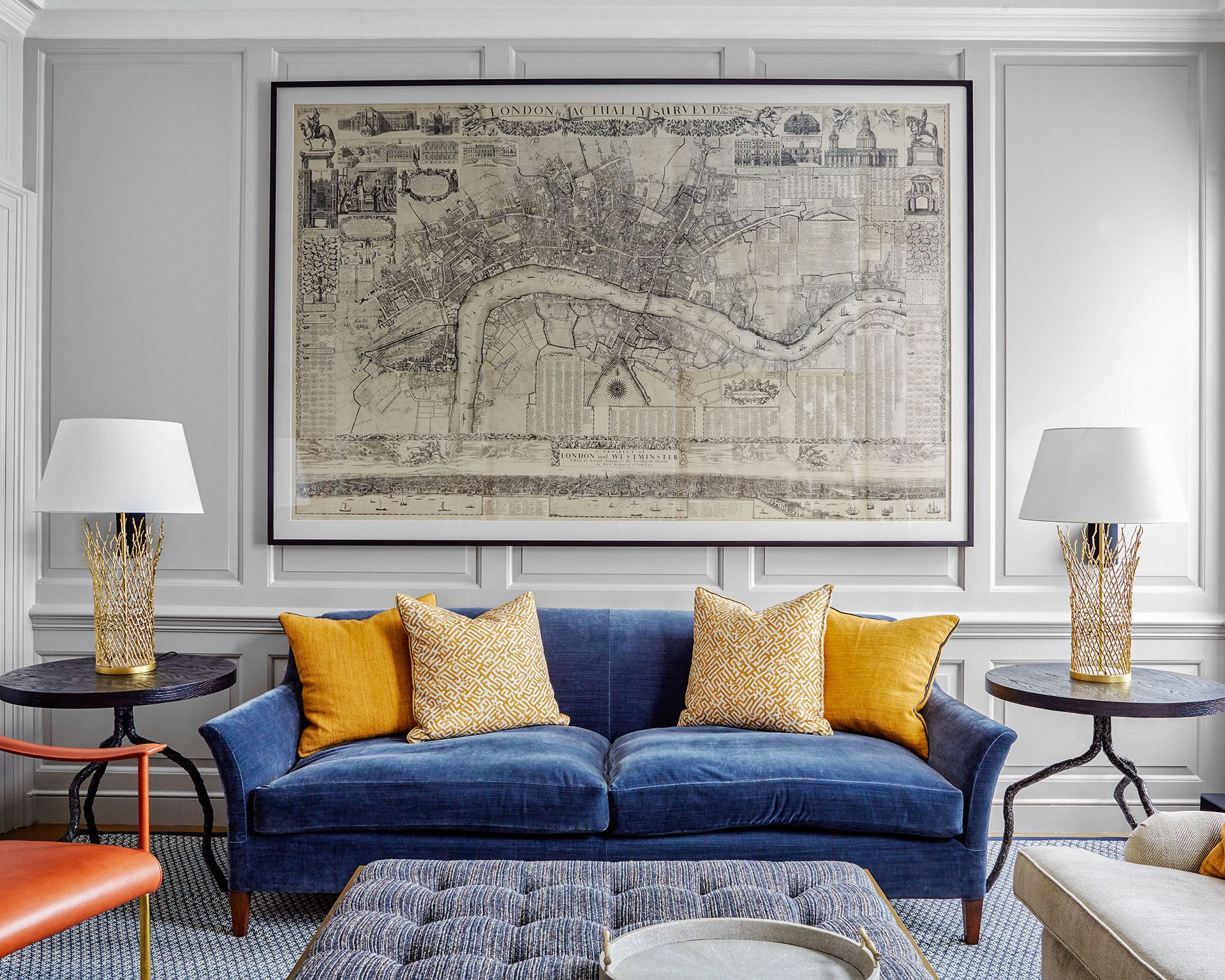 Simple living room with blue sofa and yellow cushions