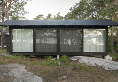 long view of swedish A house cabin in woods