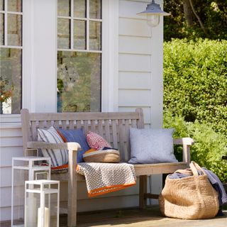 decking decoration and pillows on wooden bench