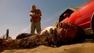Dean Norris with the gun, Raymond Cruz in the dirt