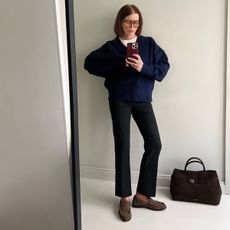 Belle wears a spring outfit with taupe loafers.