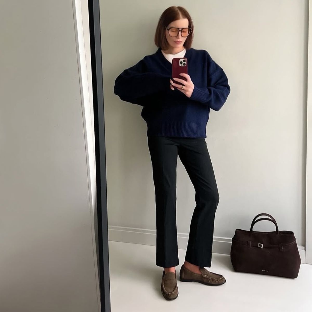 Belle wears a spring outfit with taupe loafers.