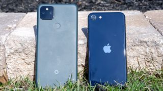 pixel 5a (left) and iphone se 2022 (right) leaning against stone