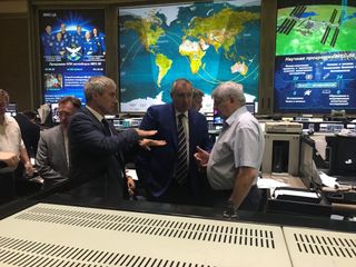 Flight controllers at Russia's Mission Control Center in Moscow discuss plans to repair a small leak in a Soyuz crew vessel docked at the International Space Station on Aug. 30, 2018.