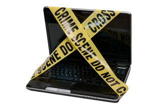 Computer covered in police tape