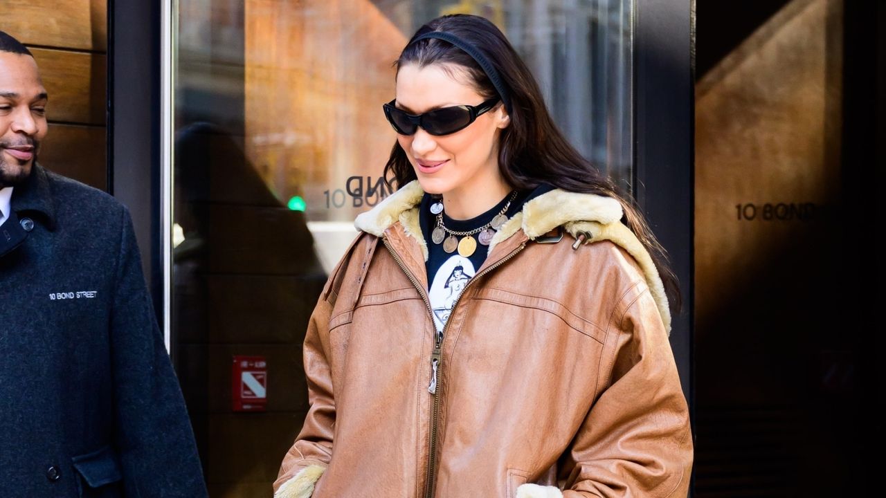 Bella Hadid wearing a shearling leather jacket and flare jeans