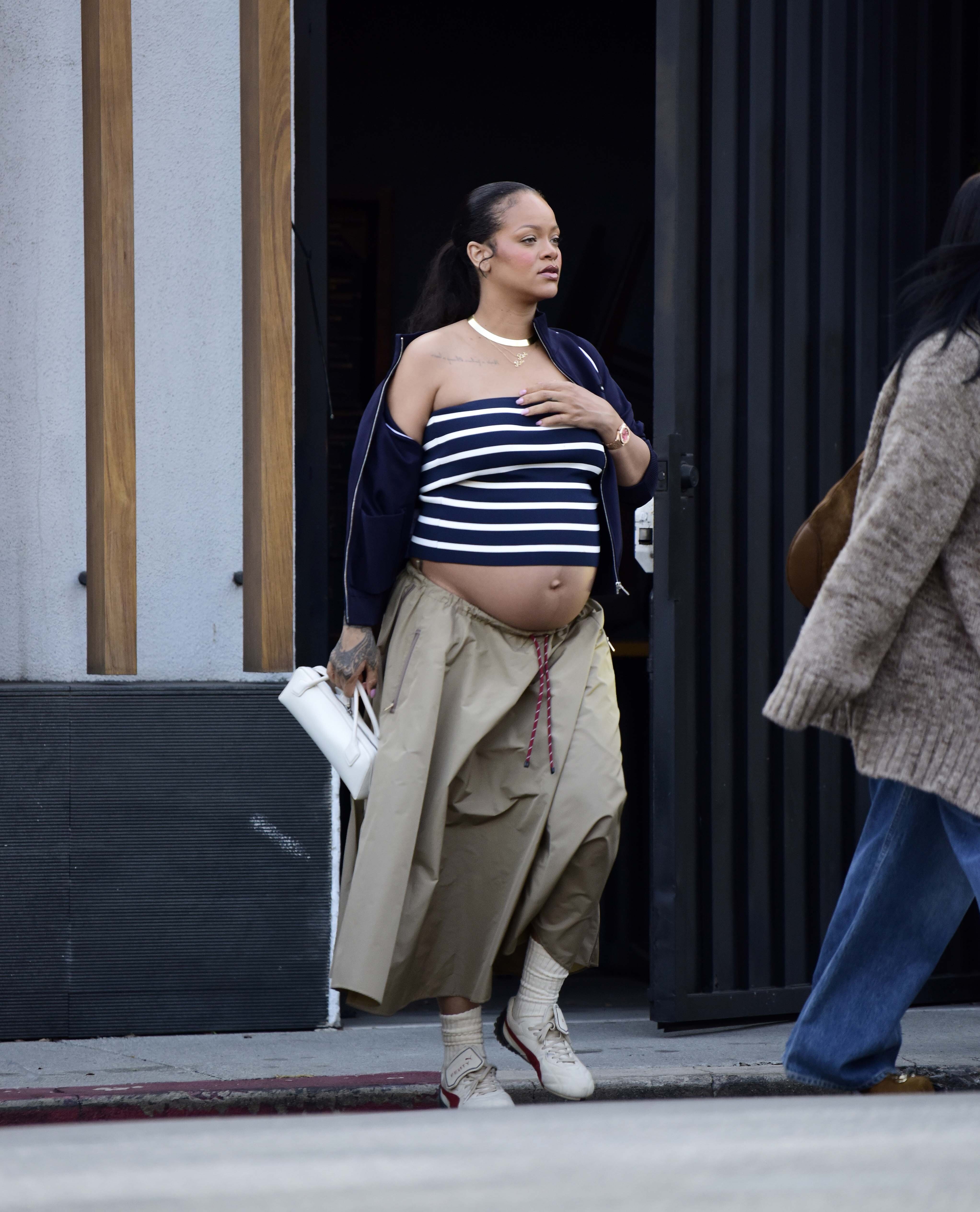 Rihanna brought back the tube top with a khaki Miu Miu skirt and Puma sneakers.