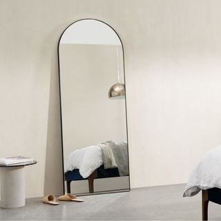 white room with floor mirror