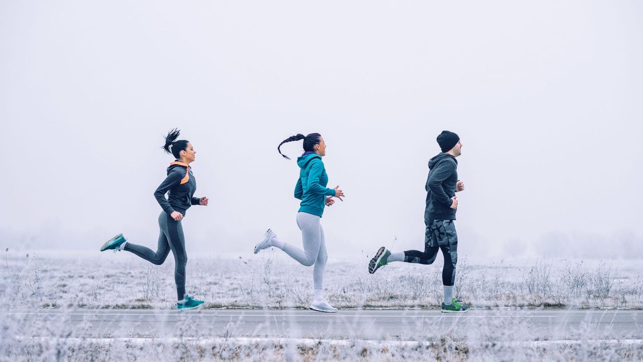 Three people exercising in winter