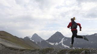 Runner wearing jacket in mountains
