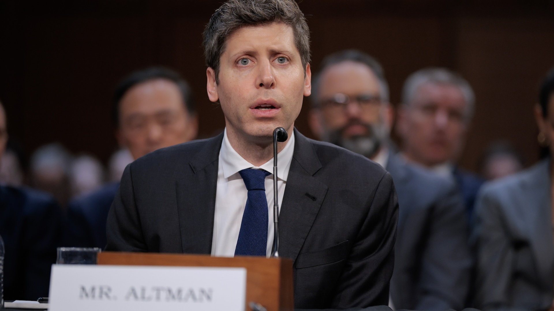 A man speaks into a microphone at a Senate hearing